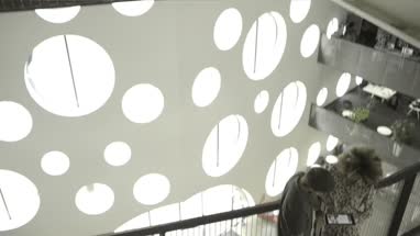 Man and woman using digital tablet in office lobby