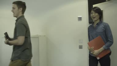 Man and woman entering in conference room and joining the meeting