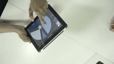 Man and woman discussing on pie chart using digital tablet 