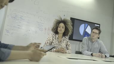 Man and women using digital tablet during meeting in conference room