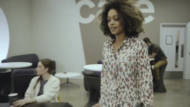 Woman using digital tablet and discussing with man in office café