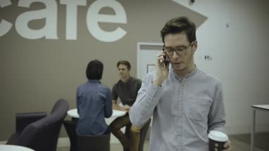 Woman using digital tablet and discussing with man in office café