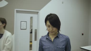 Man using digital tablet and discussing with woman in office café