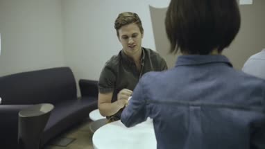 Man and woman enjoying coffee and talking in office café