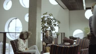 Men and women using digital tablet in business meeting