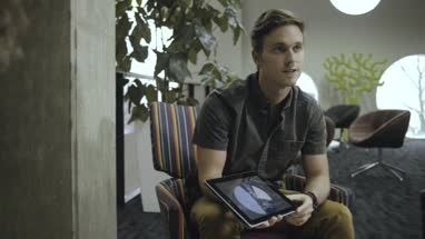 Men and women using digital tablet in business meeting