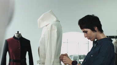 Fashion designer measuring mannequin in studio