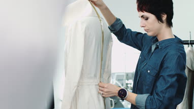 Fashion designer measuring mannequin in studio