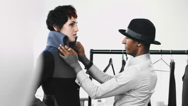 Fashion designer dressing mannequin fashion model in studio