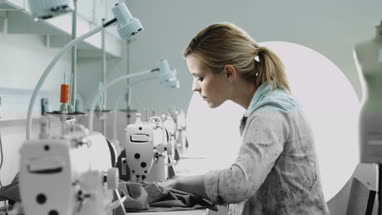 Portrait of Fashion designer looking to camera and at work in studio