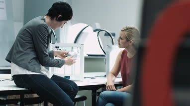 Team woman designers looking at 3D printed object