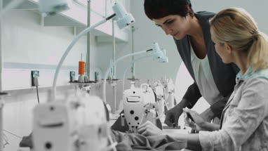 Fashion designers at sewing machine working together