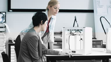 Team woman designers looking at 3D printed object