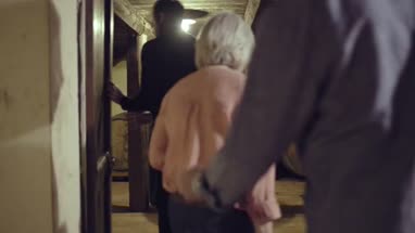Senior couple entering a wine cellar