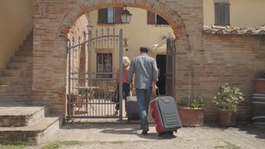 Senior couple arriving at hotel