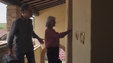 Senior couple arriving at holiday apartment