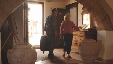 Senior couple leaving hotel