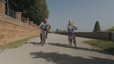 Senior couple cycling on electric bicycles