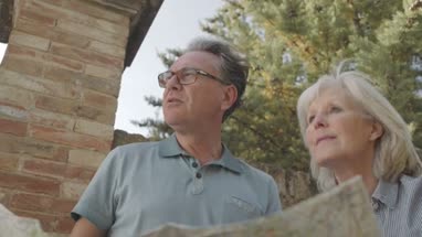 Senior couple looking at map on holiday