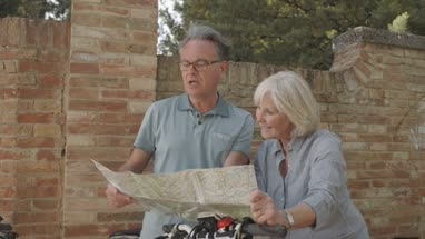 Senior couple looking at map on holiday