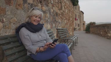 Senior woman using smart phone on bench