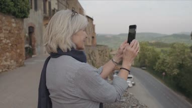 Senior woman taking photo with smart phone