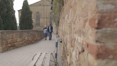 Senior couple on vacation walking in village