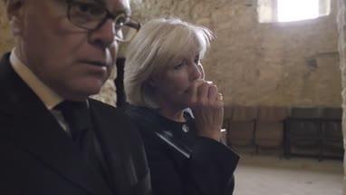 Senior Woman crying at a funeral