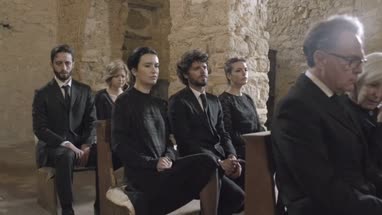 Grandmother crying at a funeral with granddaughter 