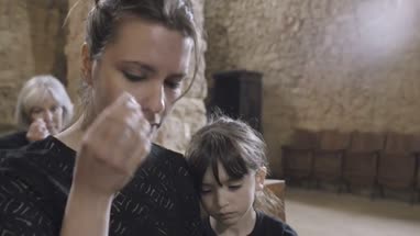 Mother with child at a funeral 