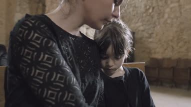 Parents with child at a funeral 