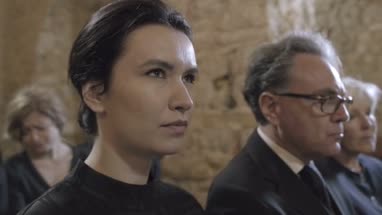 Woman mourning at funeral service in church
