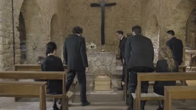 Pallbearers leaving Church with coffin followed by family