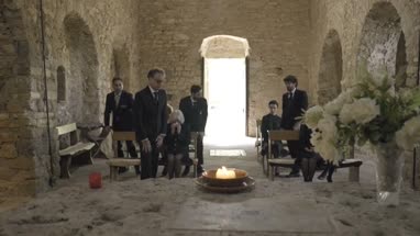 Pallbearers leaving Church with coffin followed by family