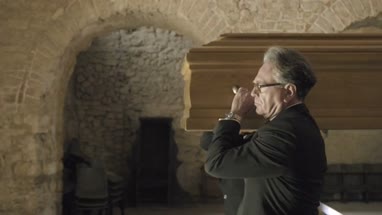 Pallbearers leaving Church with coffin followed by family
