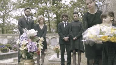 Mother and Daughter laying flowers on grave