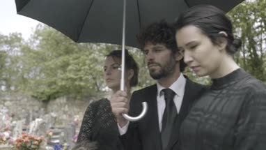 Family Mourning on graveyard at funeral