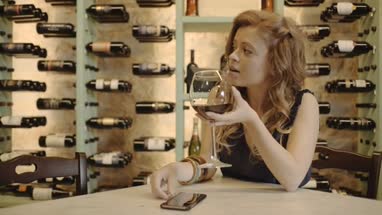 Young adult checking smart phone at wine bar 