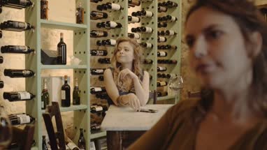 Young adult checking smart phone at wine bar 