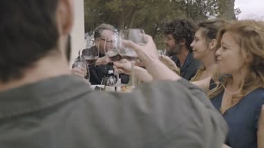 Family toasting with wine outdoors