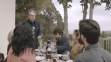 Senior giving speech to family at meal