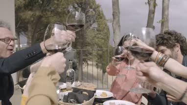 Family celebrating and toasting with wine