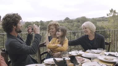 Father taking picture of family meal