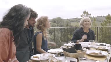 Granddaughter taking picture of family meal