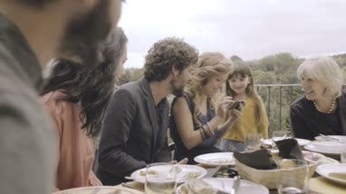 Daughter showing smartphone to parents