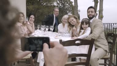 Family posing for photo on wedding day