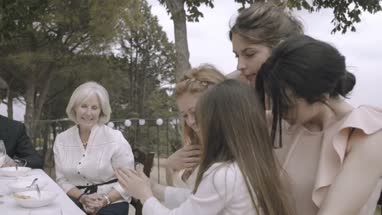 Bride and bridesmaids looking at photos