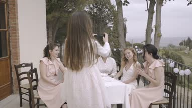 Bride and bridesmaids looking at photos