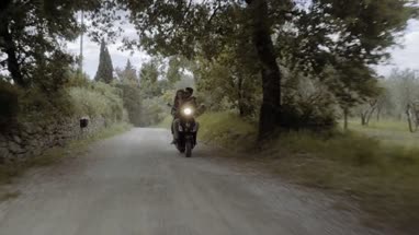 Young couple riding on scooter 