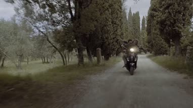 Young couple riding on scooter 